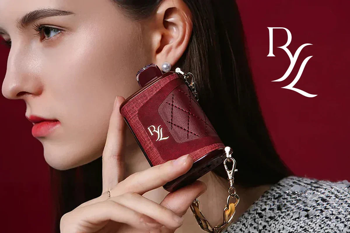 Woman holding a red RAZ RYL Classic 35K disposable vape with luxury leather finish and gold chain lanyard against a burgundy background.